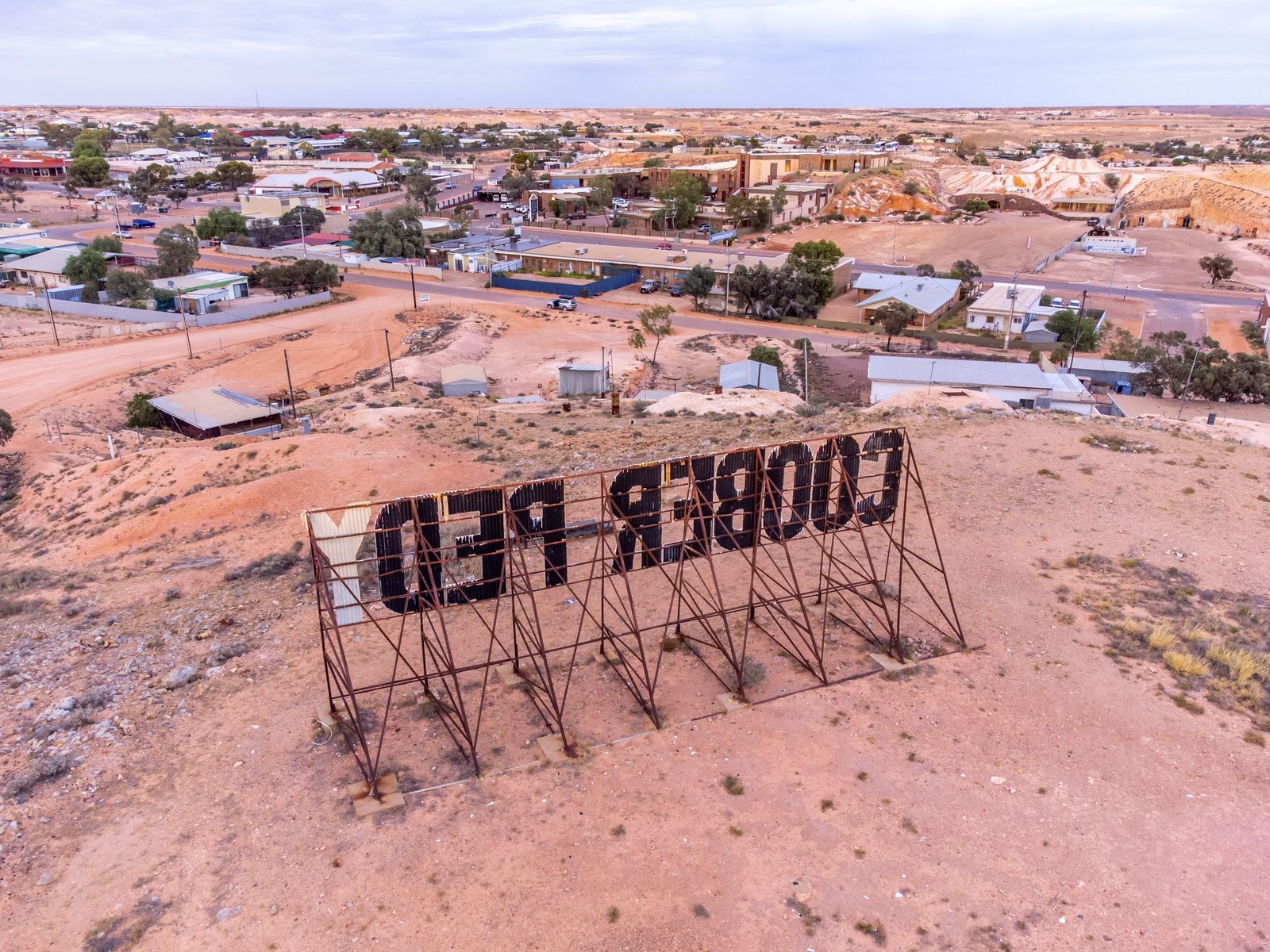 Aerial view of the Coober Pedy sign and township. Photo: Tourism Australia