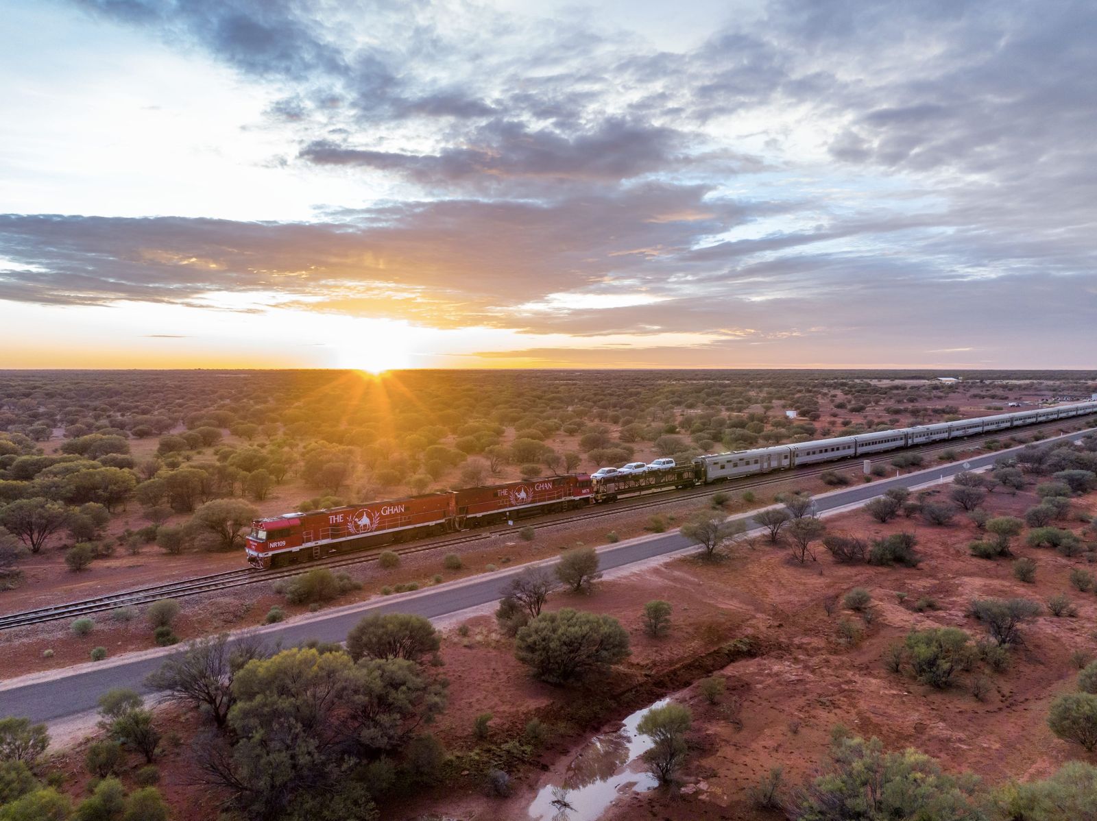 Aerial view of The Ghan in the outback at sunset