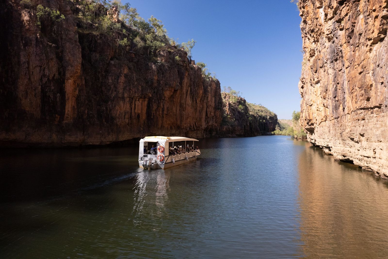 A cruise boat between the sandstone walls of Nitmiluk Gorge near Katherine. Photo: Tourism Australia