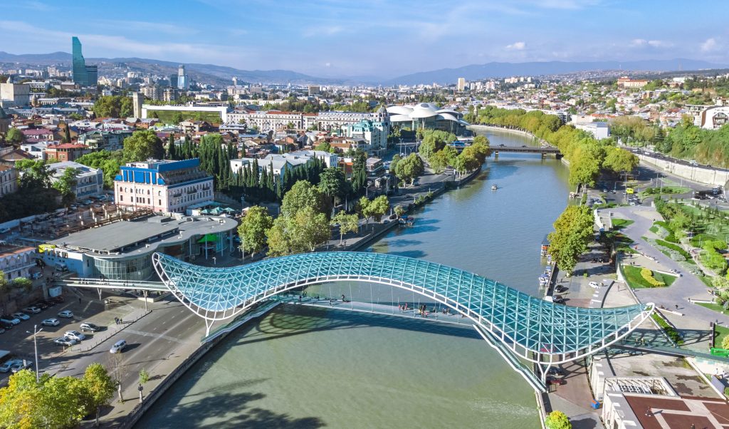 Aerial view shows the Peace Bridge, a glass and steel pedestrian bridge over the Kura River in Tbilisi, Georgia.