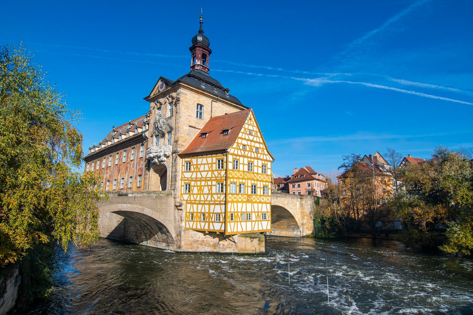Bamberg's Old Town Hall standing on its bridge over the river