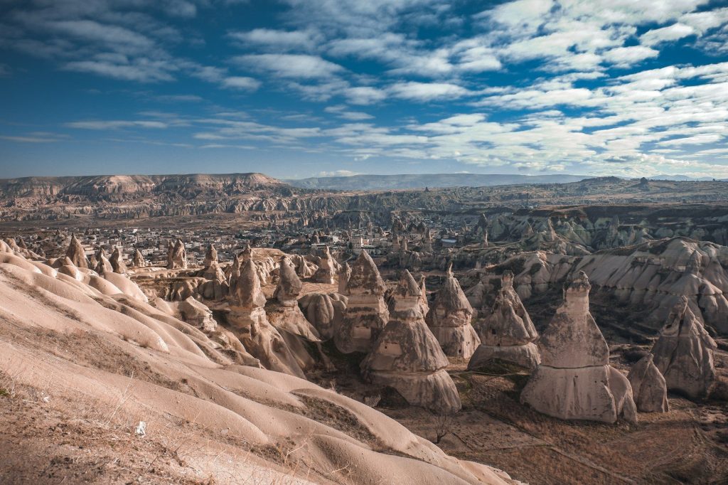 Rock formations and fairy chimneys across a valley in Cappadocia, Turkey.