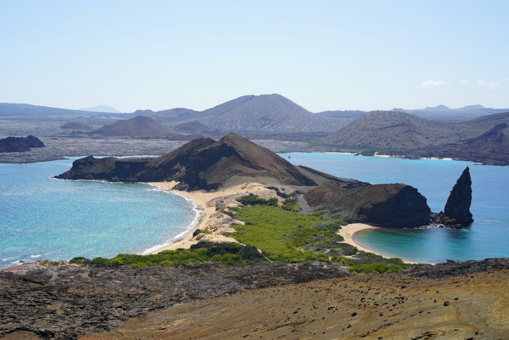 An island with a sandy beach and blue water — Isabela Island, Galápagos