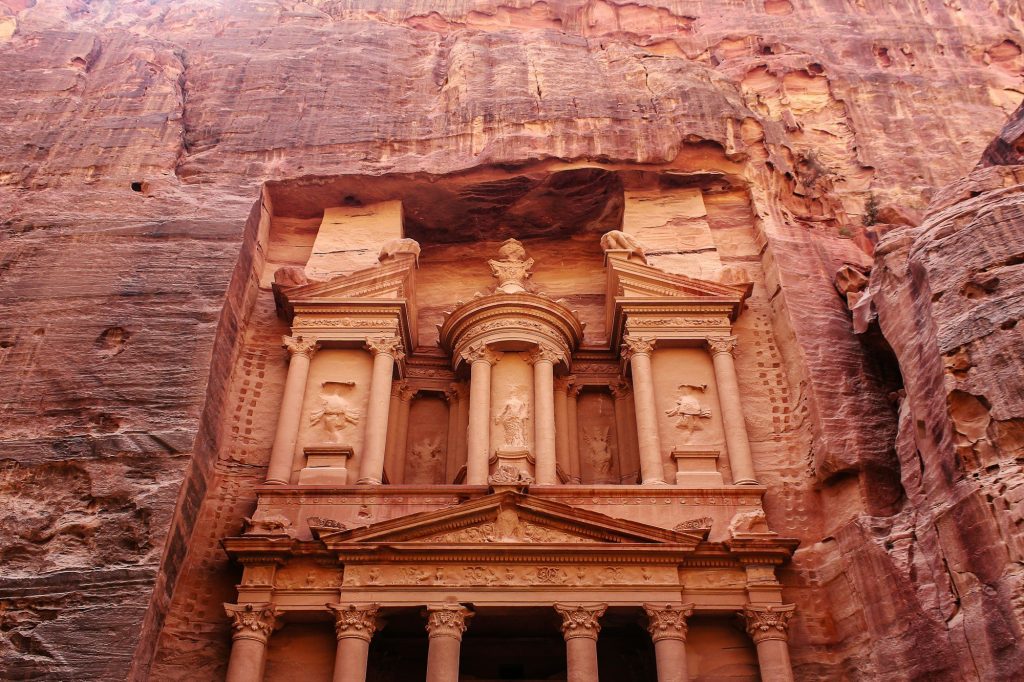 A tomb facade carved into the sandstone cliffs of Petra, Jordan
