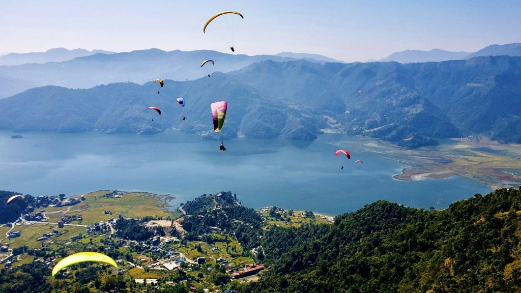 Paragliders over the hills above Phewa Lake — Phewa Lake, Pokhara, Nepal