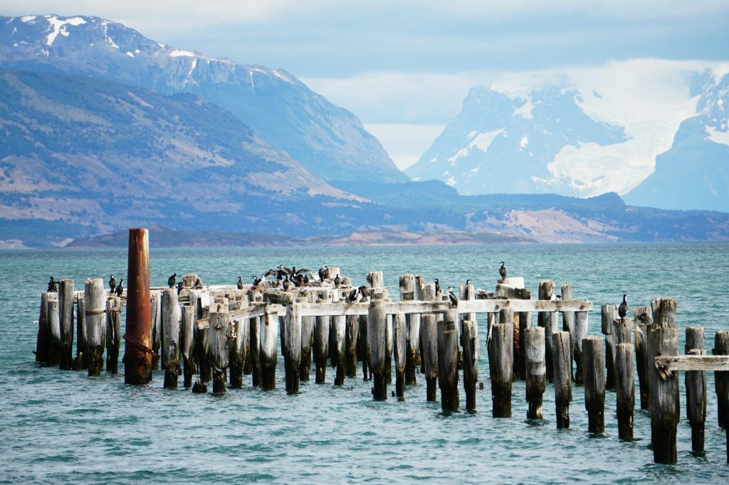 The old pier at Puerto Natales with snow-capped mountains, Chile